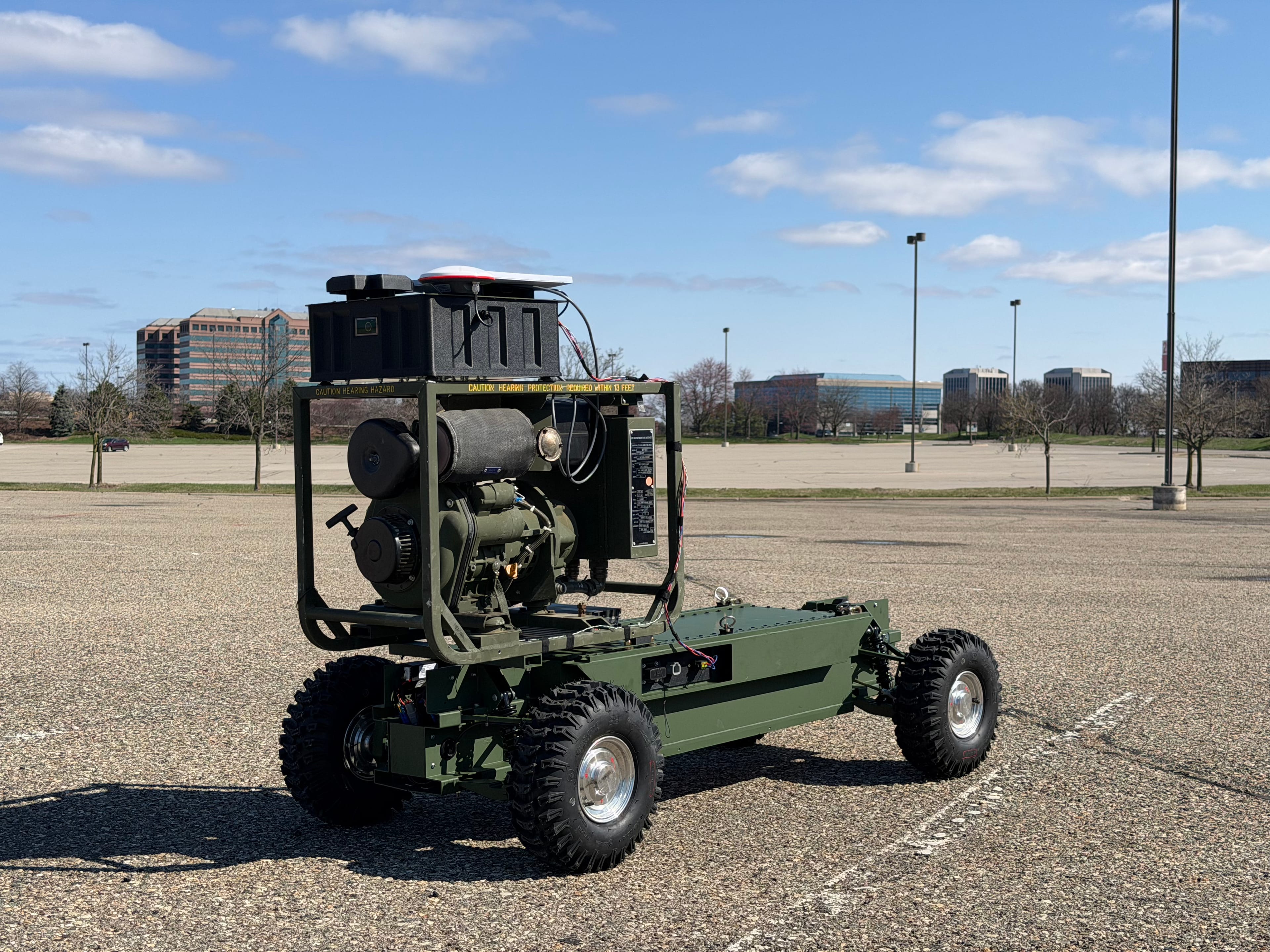 Ghostrunner deployed in an open lot with an industrial skyline behind
